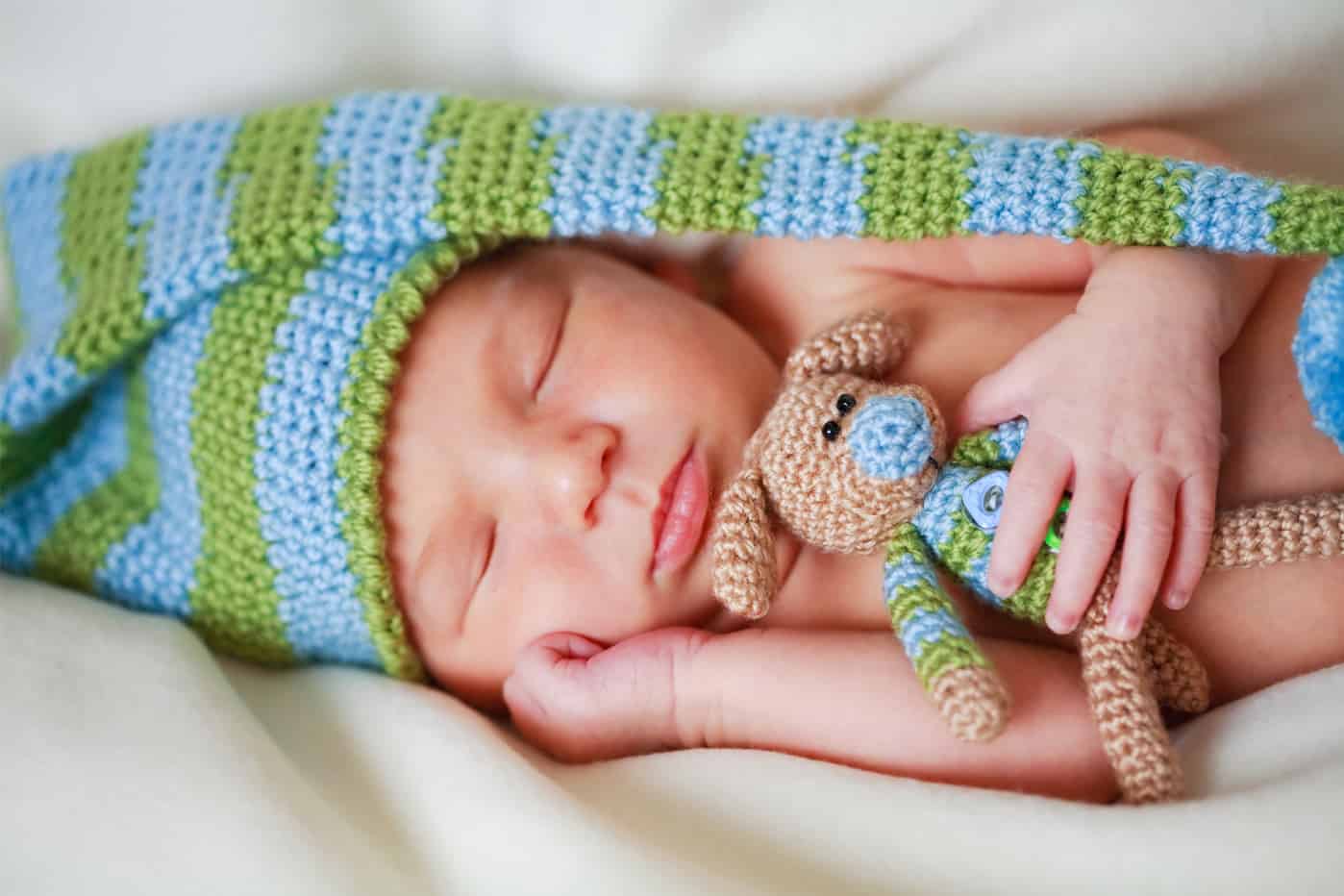 Adorable newborn baby with teddy newborn